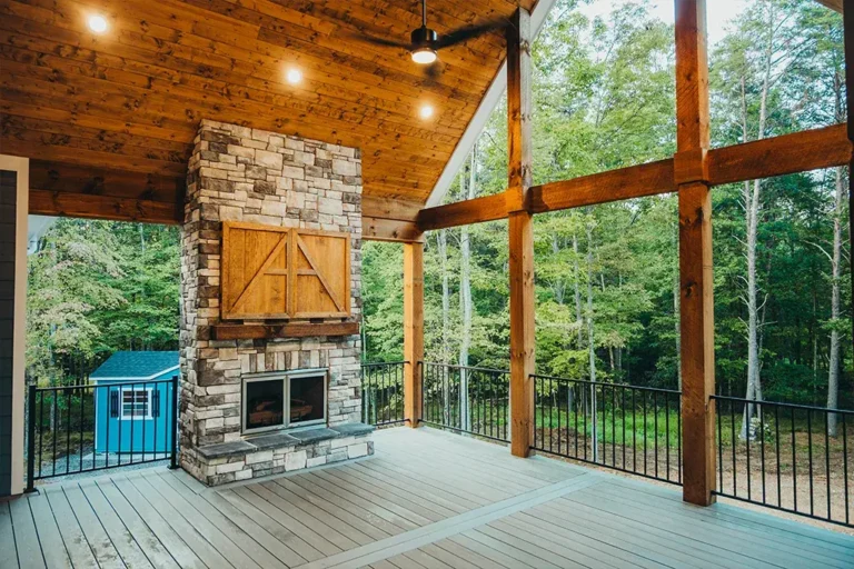 Screened porch with stone fireplace - Cole Construction custom home